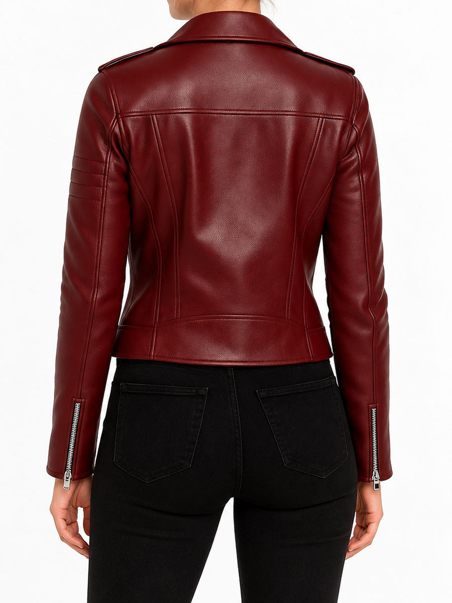 Burgundy leather biker jacket back view on female model showing fitted silhouette, stitched leather panels, and zippered cuffs.